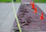 Record high temperatures cause this pavement to buckle as the concrete expanded