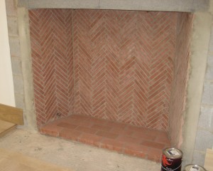 HeatStop Refractory Mortar was used to construct this herringbone-pattern fireplace. Whitacre Greer Red Firebrick Splits are featured.